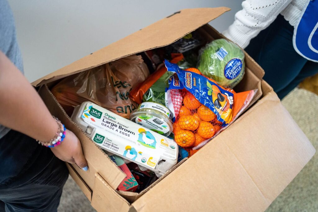 loavesAndFishesVolunteersPackingBoxesOfRescuedFood-scaled